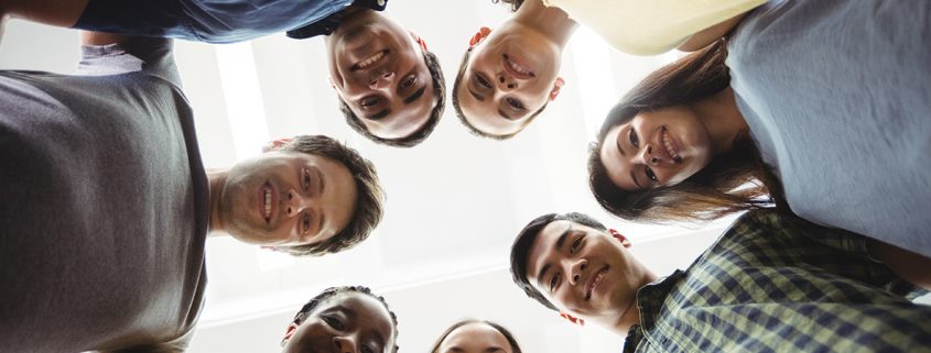 Group of business executives forming huddle